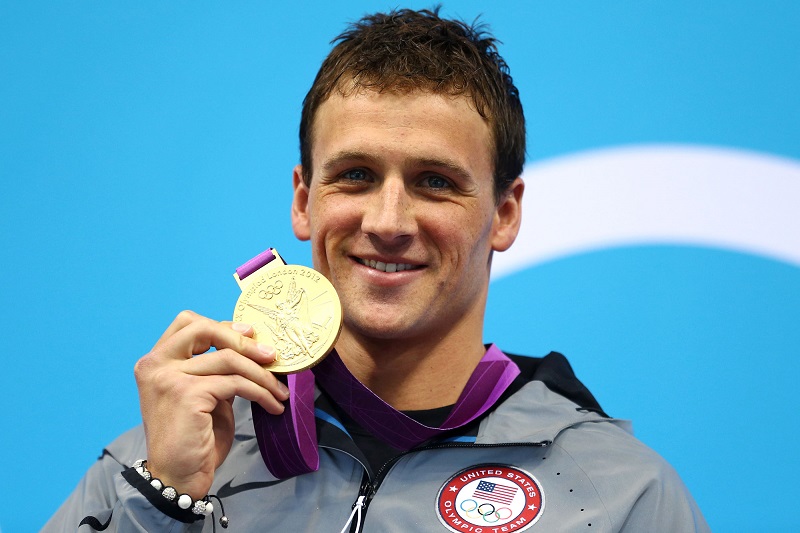 LONDON, ENGLAND - JULY 28: Ryan Lochte of the United States celebrates with his Gold Medal during the Medal Ceremony for the Men's 400m Individual Medley on Day 1 of the London 2012 Olympic Games at the Aquatics Centre on July 28, 2012 in London, England. (Photo by Al Bello/Getty Images)